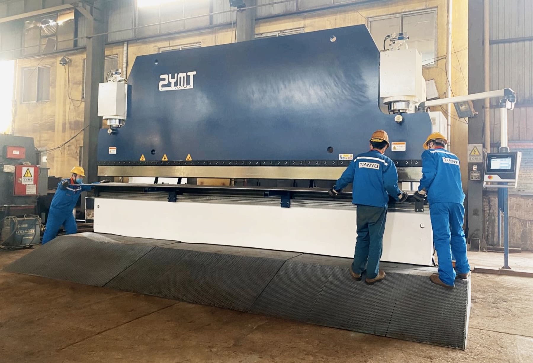 TIANYU operators running a CNC press brake
